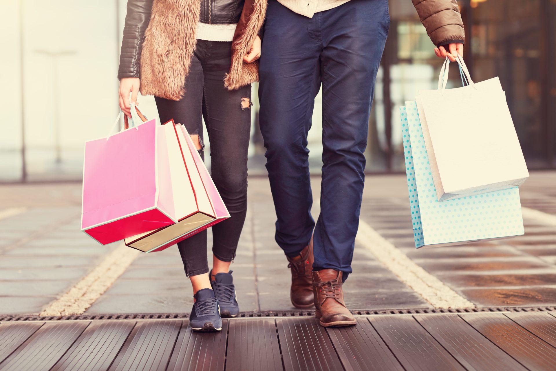 couple walking holding shopping bags
